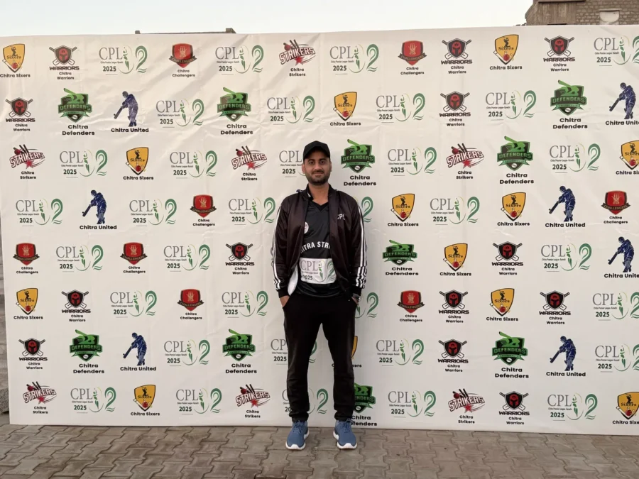 A player in a black kit in front of the CPL sponsor wall