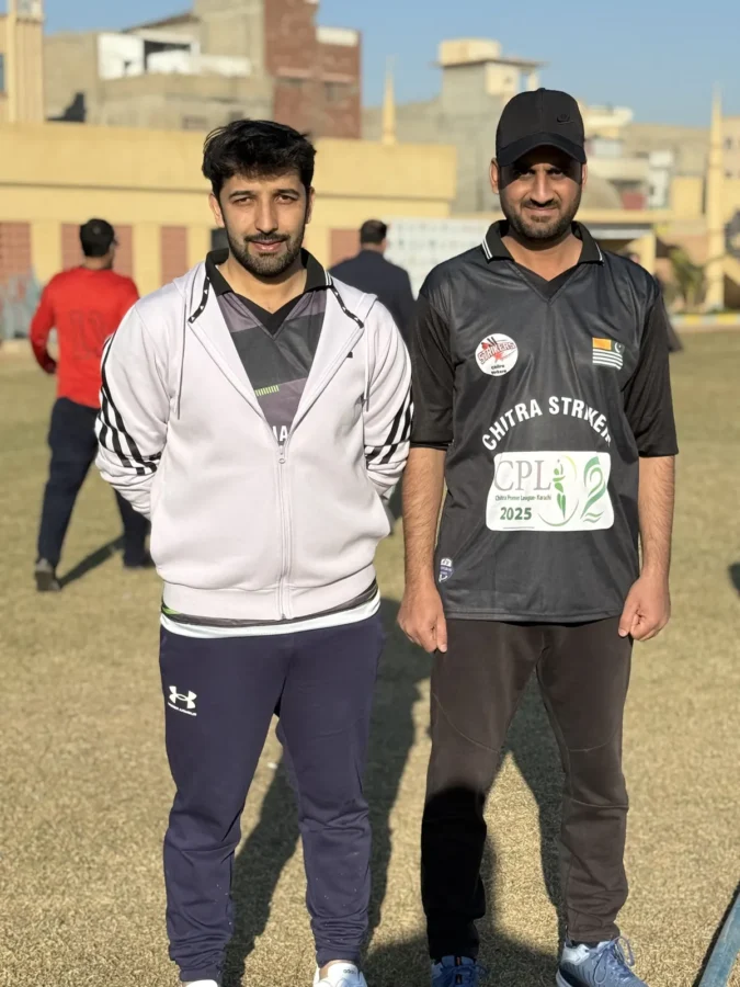 Two players standing together at the ground