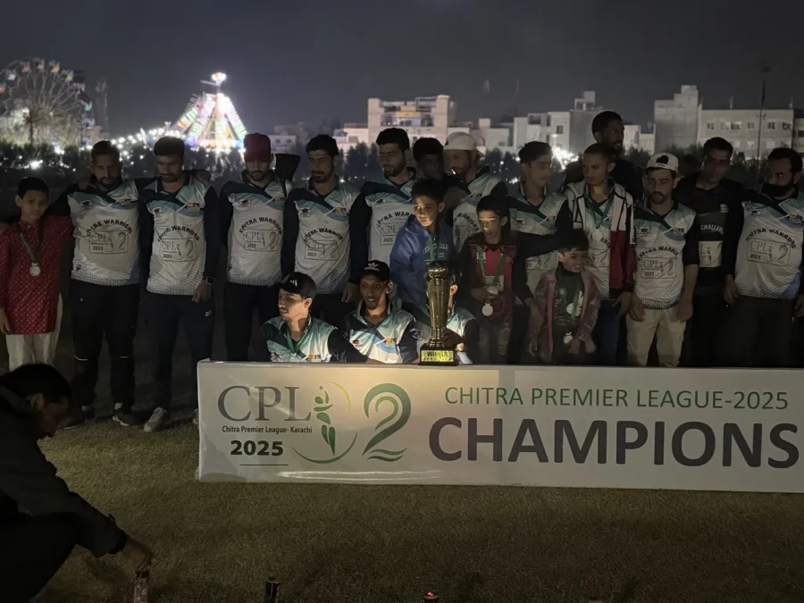 The champions and organizers at night under the lights